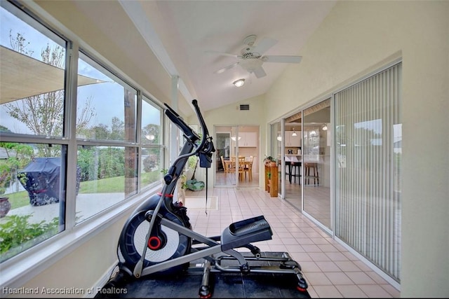 exercise area with lofted ceiling, light tile patterned floors, and ceiling fan