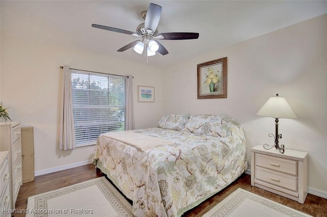 bedroom with dark hardwood / wood-style flooring and ceiling fan