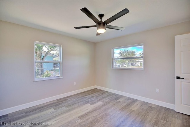 unfurnished room featuring light hardwood / wood-style flooring and ceiling fan