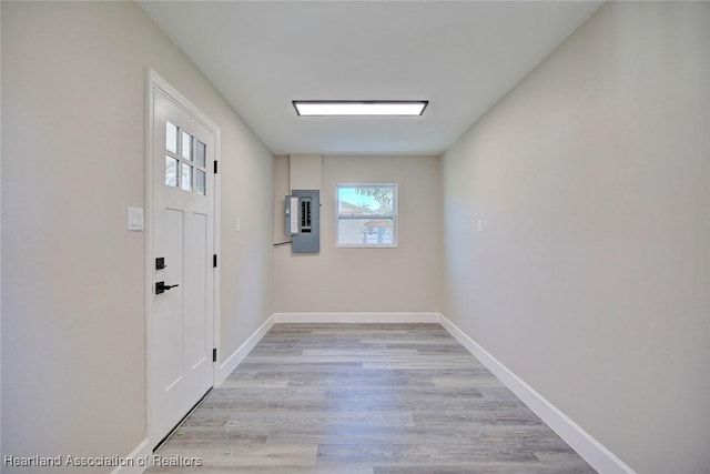 doorway with light hardwood / wood-style flooring and electric panel