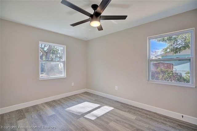 empty room featuring light hardwood / wood-style flooring and ceiling fan