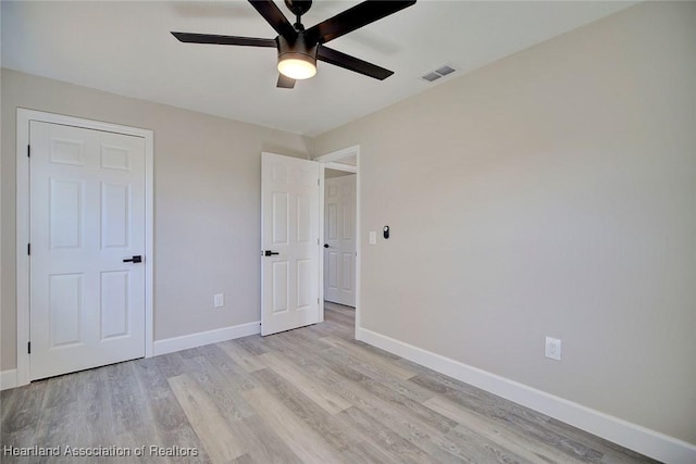 unfurnished bedroom with light hardwood / wood-style floors and ceiling fan