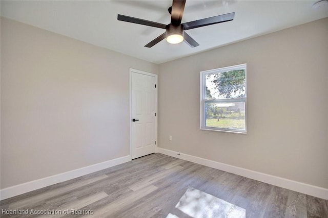 empty room with ceiling fan and light wood-type flooring