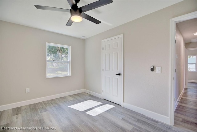 unfurnished bedroom featuring light wood-type flooring and ceiling fan