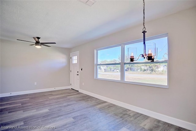 entrance foyer featuring hardwood / wood-style flooring, ceiling fan with notable chandelier, and a textured ceiling