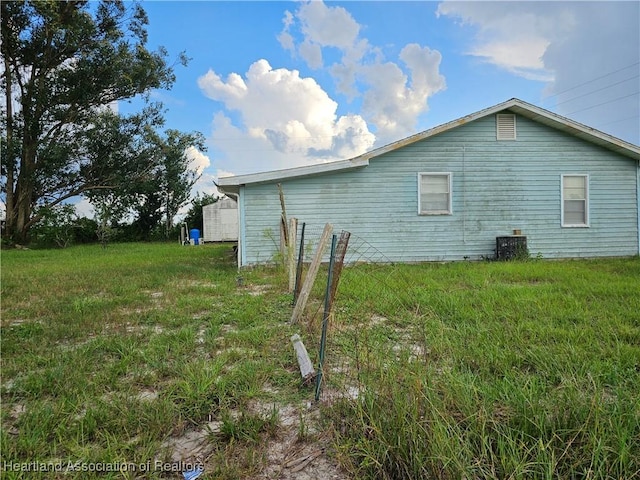 view of side of home featuring a yard