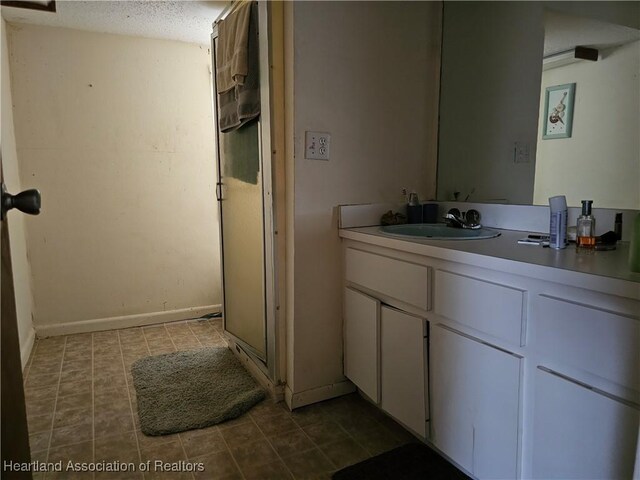 bathroom featuring vanity and a textured ceiling