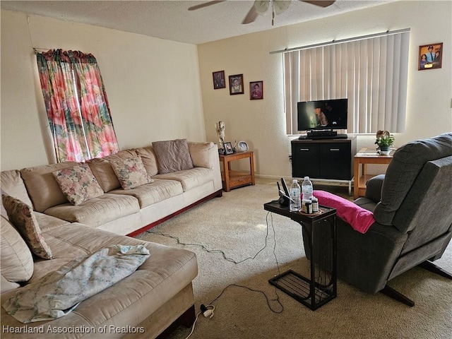 carpeted living room with ceiling fan