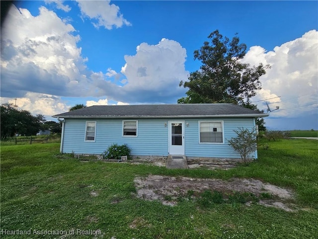 back of property featuring a yard