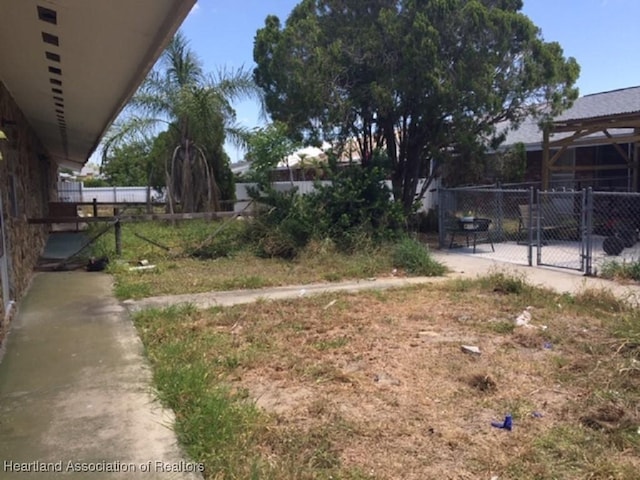 view of yard with fence and a gate