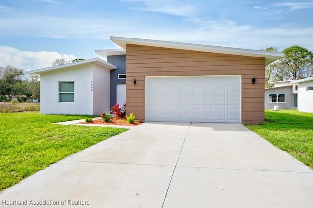 view of front of home featuring a garage and a front yard