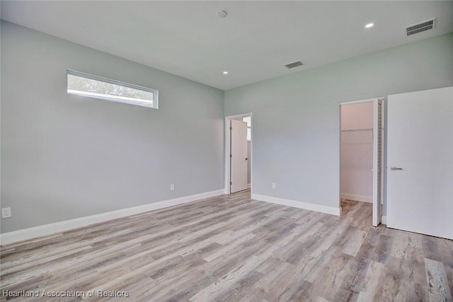 spare room featuring light hardwood / wood-style flooring