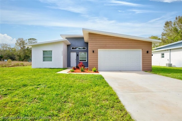 view of front of home with a garage, a front lawn, and cooling unit