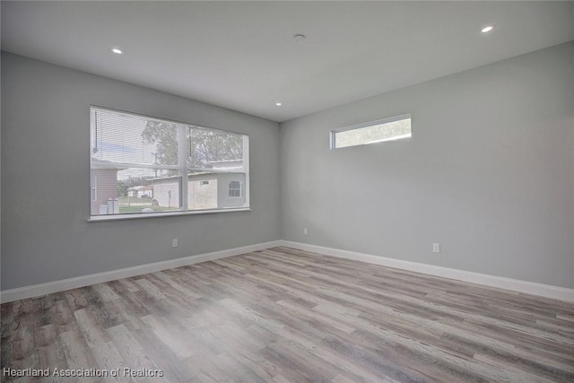 unfurnished room with light hardwood / wood-style floors