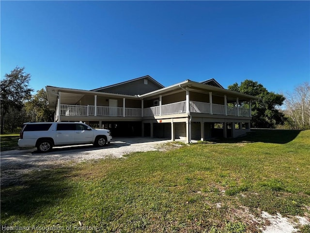 exterior space featuring a front lawn and a carport