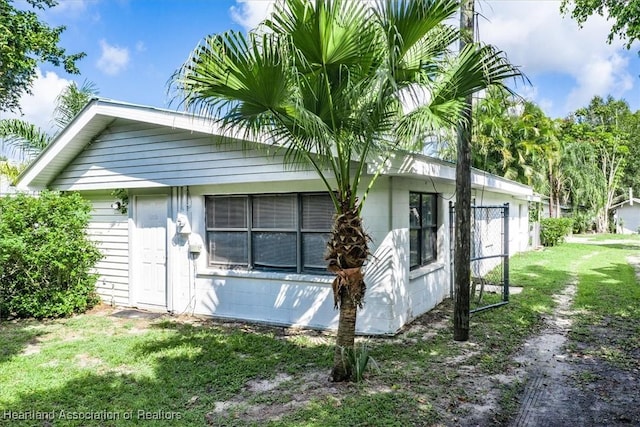 view of side of home with a lawn