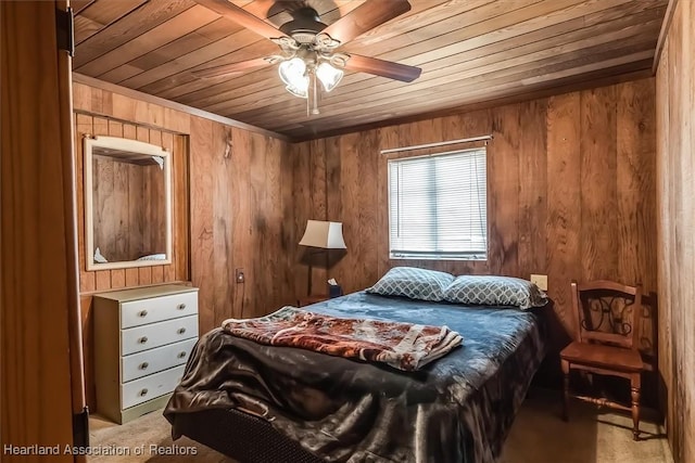 bedroom with ceiling fan, wood walls, and wooden ceiling