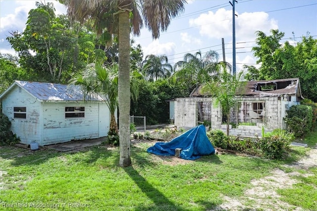 view of play area with a yard and an outbuilding