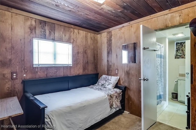 bedroom with wood walls, light carpet, and wooden ceiling