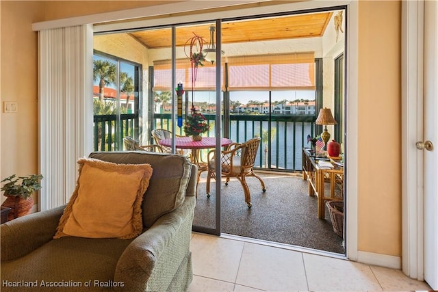 sunroom featuring a water view