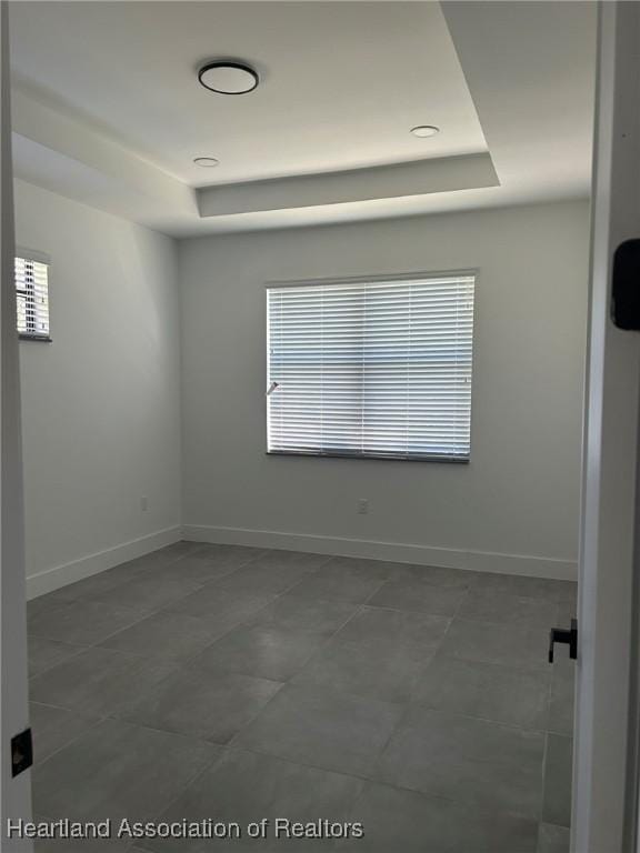 empty room featuring a tray ceiling