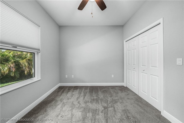 unfurnished bedroom featuring carpet flooring, ceiling fan, and a closet