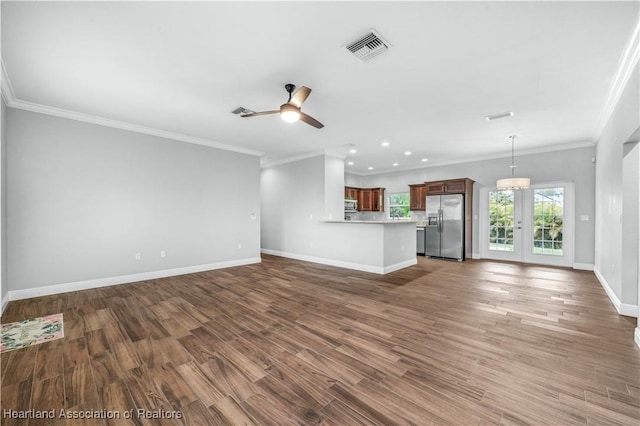 unfurnished living room featuring dark hardwood / wood-style flooring, crown molding, and ceiling fan