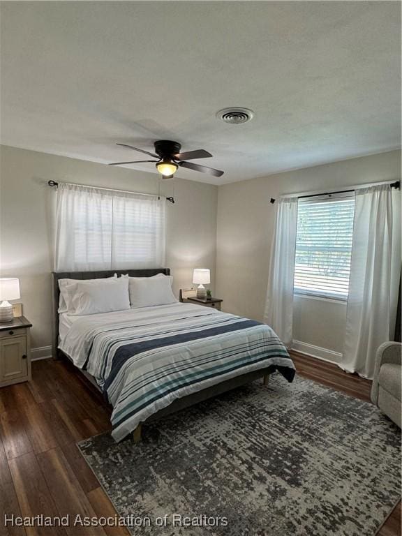 4350 Lakeview Dr, Sebring, FL 33870 - bedroom with baseboards, ceiling fan, dark wood-style floors, and visible vents