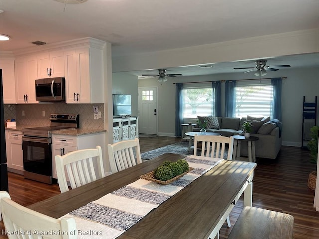 4350 Lakeview Dr, Sebring, FL 33870 - dining area featuring baseboards, ceiling fan, and dark wood-style floors