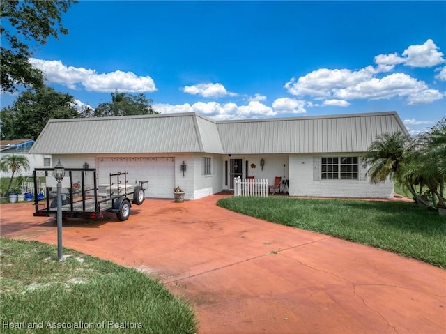 view of front of property with a front lawn and a garage