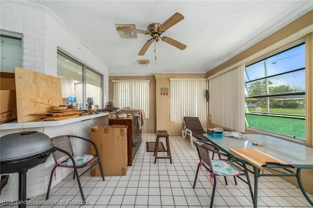 sunroom featuring ceiling fan and a wealth of natural light