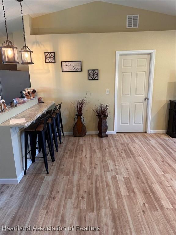 2633 W Newton Rd, Avon Park, FL 33825 - dining room with visible vents, baseboards, lofted ceiling, and light wood-style floors
