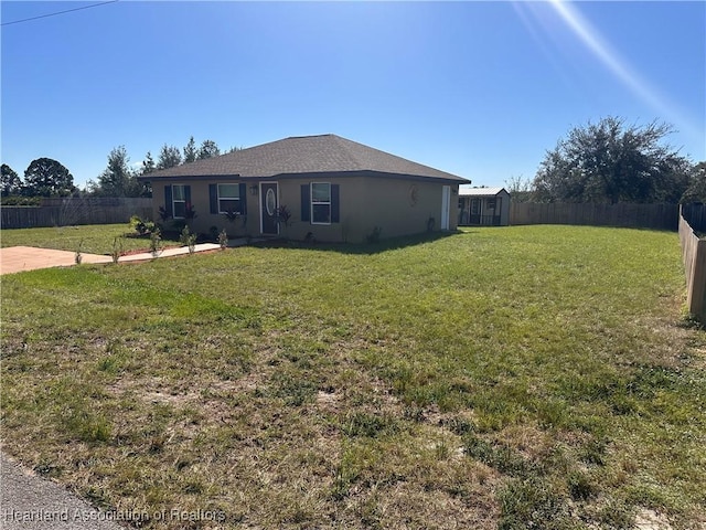 2633 W Newton Rd, Avon Park, FL 33825 - single story home featuring a front lawn, stucco siding, a fenced backyard, and a patio area