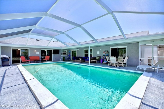outdoor pool with a patio, outdoor lounge area, and a lanai