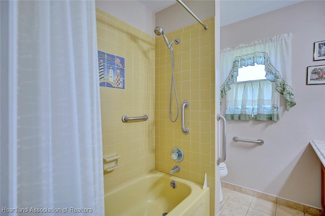 bathroom featuring shower / bath combination with curtain, tile patterned floors, baseboards, and toilet