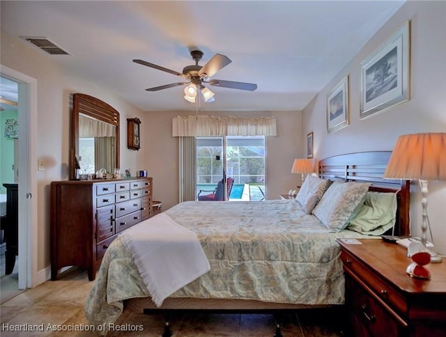 bedroom with access to outside, ceiling fan, visible vents, and tile patterned floors