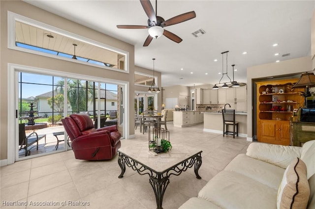 living room featuring visible vents, baseboards, a ceiling fan, recessed lighting, and light tile patterned flooring