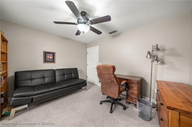office area with visible vents, ceiling fan, and carpet floors