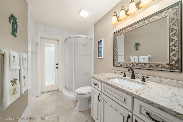 full bathroom with a shower stall, tile patterned flooring, vanity, and toilet