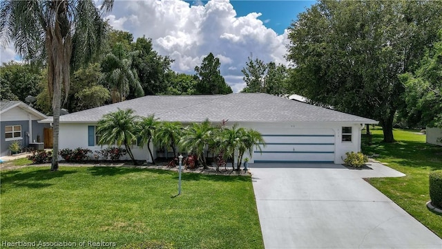 single story home with a garage and a front lawn