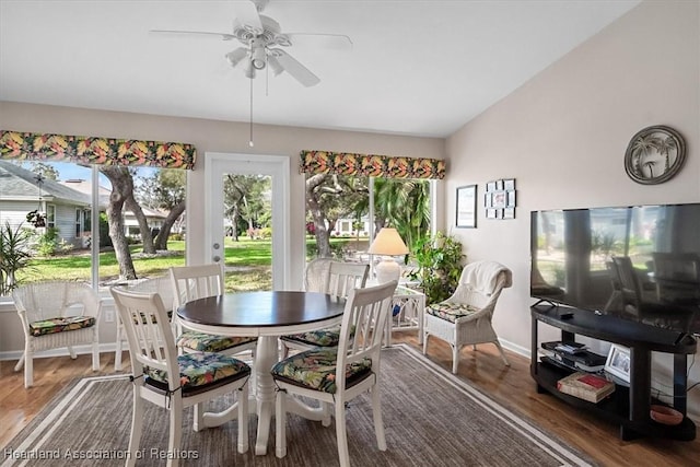 dining room featuring vaulted ceiling, dark hardwood / wood-style floors, and ceiling fan