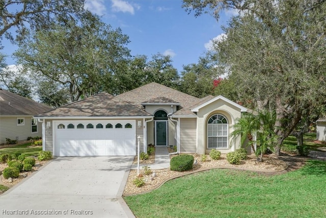 ranch-style home with a garage and a front lawn