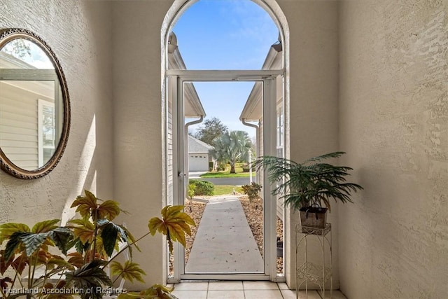 doorway to outside featuring light tile patterned flooring