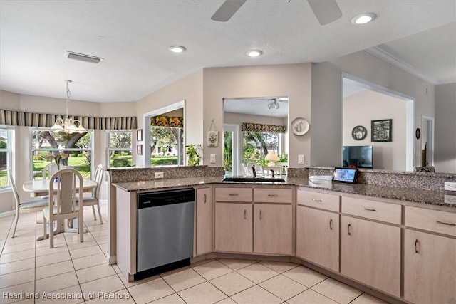 kitchen featuring light brown cabinetry, sink, dark stone countertops, dishwasher, and ceiling fan with notable chandelier