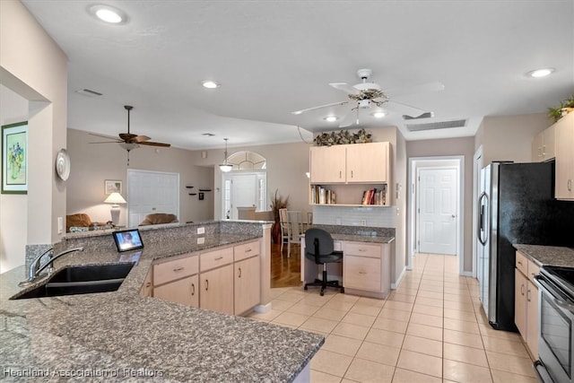 kitchen featuring built in desk, light brown cabinetry, sink, dark stone countertops, and kitchen peninsula