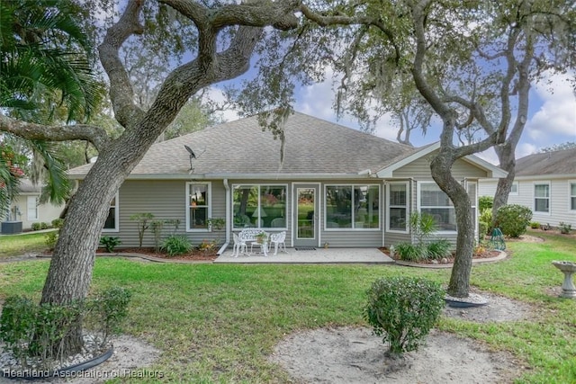 back of property with central AC, a yard, and a patio area