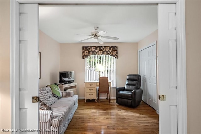 living room with hardwood / wood-style floors and ceiling fan