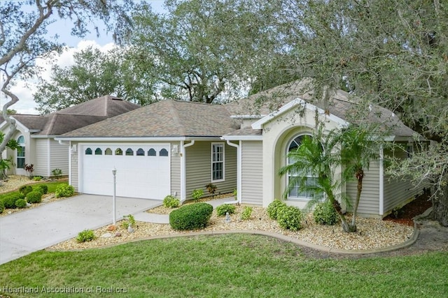 ranch-style home featuring a garage and a front yard