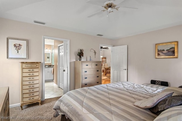 carpeted bedroom with connected bathroom and ceiling fan