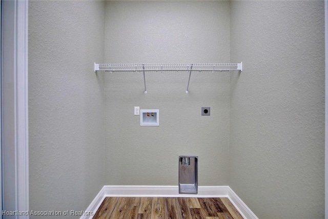 clothes washing area featuring hookup for a washing machine, electric dryer hookup, and wood-type flooring